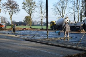 Robotnicy wygładzający wylany beton na placu, na którym powstanie skatepark